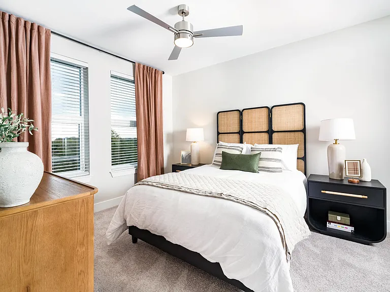 A bright primary bedroom with generous natural light, soft finishes, and a calm layout designed for everyday comfort and ease.