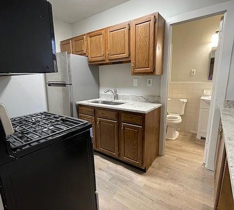 Standing in doorway of bedroom area looking into the kitchen. The bathroom is just beyond the kitchen. New flooring was put in the kitchen and bathroom.