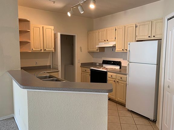 Kitchen and doorway into utility closet with washer and dryer
