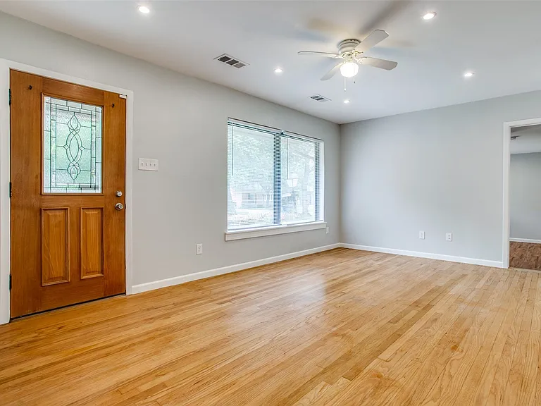 Light and bright open floor plan with wood flooring.