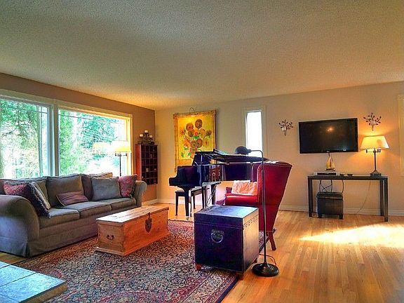 Inviting and flowing floor plan with gleaming hardwood floors throughout will lead you to the large living room with a fireplace and picture windows.