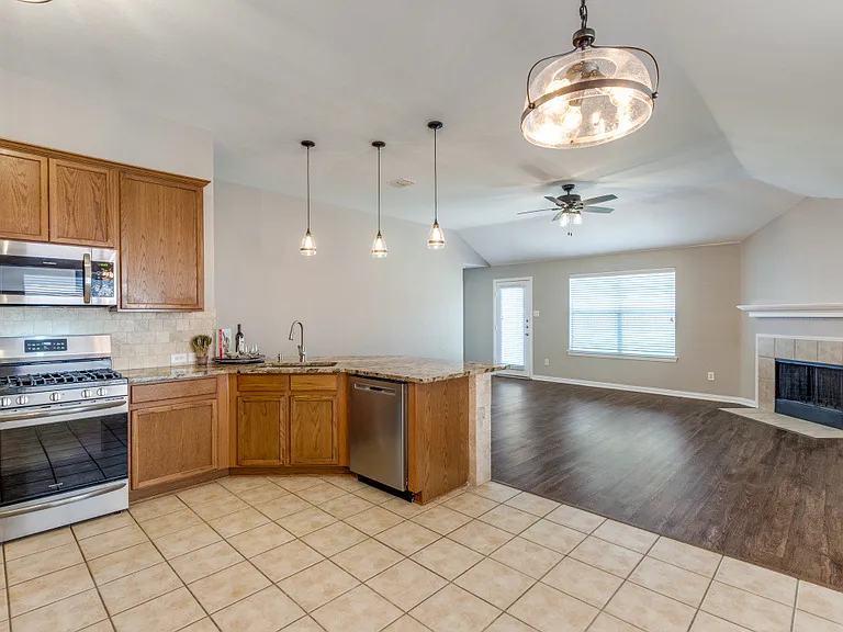 Kitchen offers updated lighting, recent appliances, granite countertops, one large deep sink, built in soap dispenser.