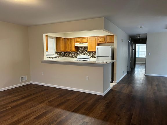full view of main hallway kitchen living room and dining area