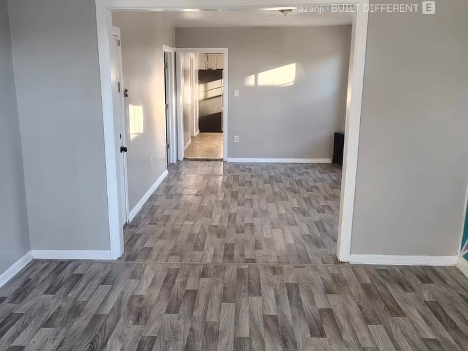 Living room looking into Dining Room and hallway to Bathroom/Kitchen