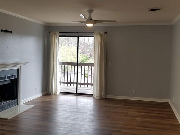 Living room with wood burning fp and sweet deck with a great view.