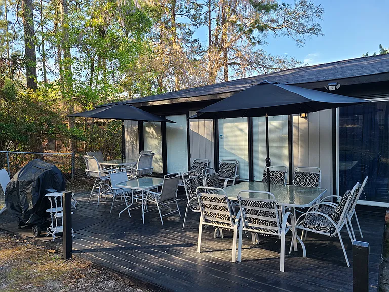 Huge patio deck with 18-20 person seating available with barrel charcoal grill, large hibachi grill and fish fryer equipment available for use. Bright solar lighting for night entertainment!