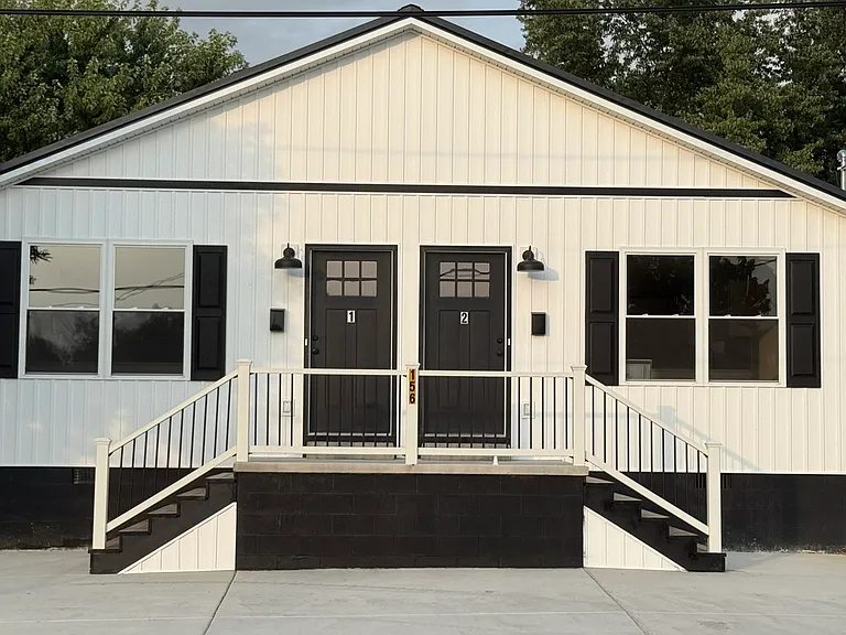Spacious private front parking with one dedicated off-street parking space for each unit, convenient front-door access, attractive front porch, and energy-efficient LED exterior lighting for added visibility and convenience.