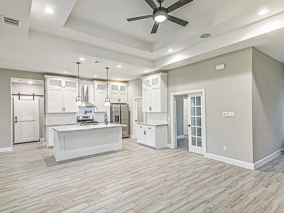 Custom hand selected and cut natural quartzite, soft close cabinets, 5 burner gas range, butlers pantry.