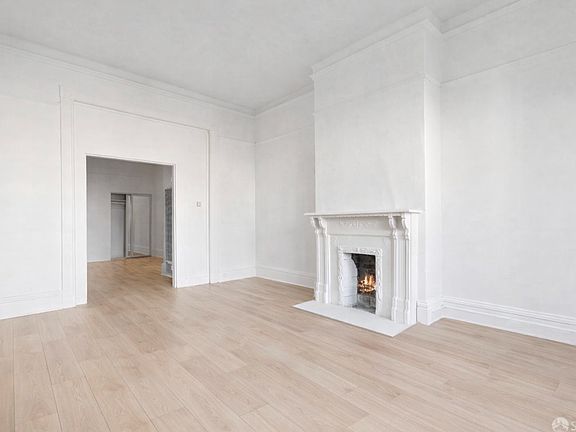Expansive living room with high ceilings and new luxury vinyl floors