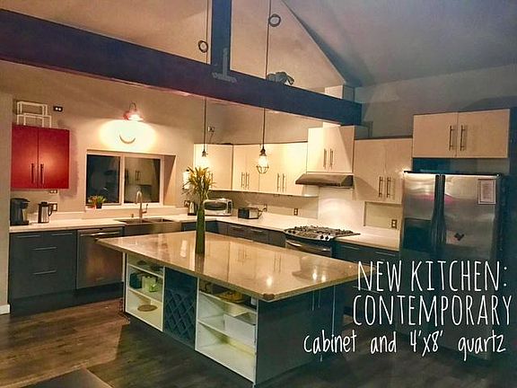 Open floor plan in the living space and kitchen with high end kitchen cabinets and quartz countertops (including a 4x8 island).