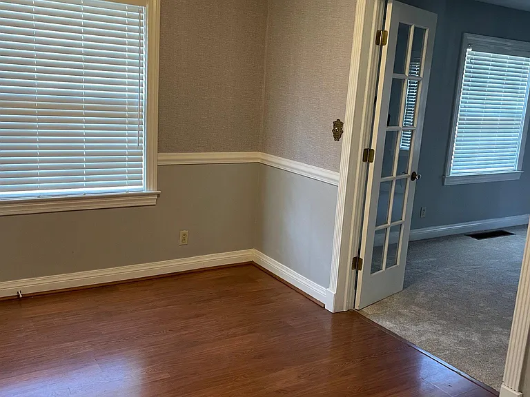 Dining room leading into the living room through lovely French doors.