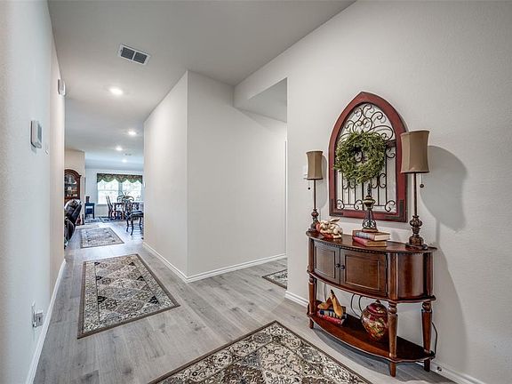Hallway featuring light wood-type flooring, baseboards, and recessed lighting