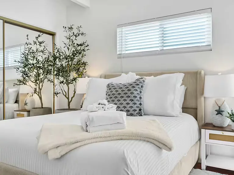 The bedroom 2 features a queen bed and direct access to the balcony