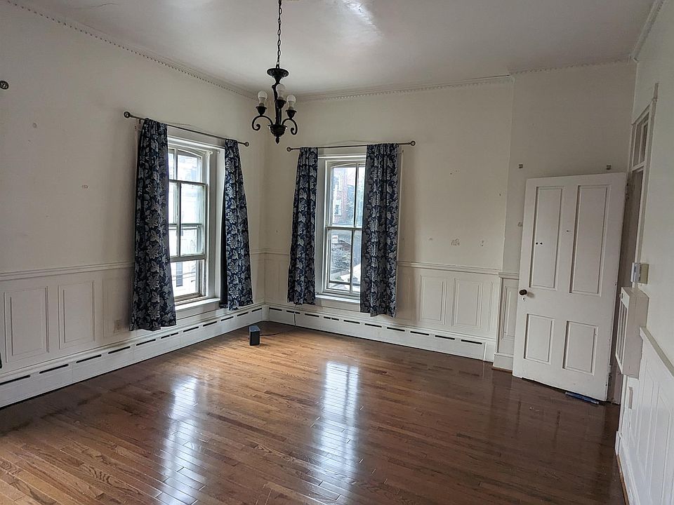 Living room with tall ceilings and beautiful hardwoods!