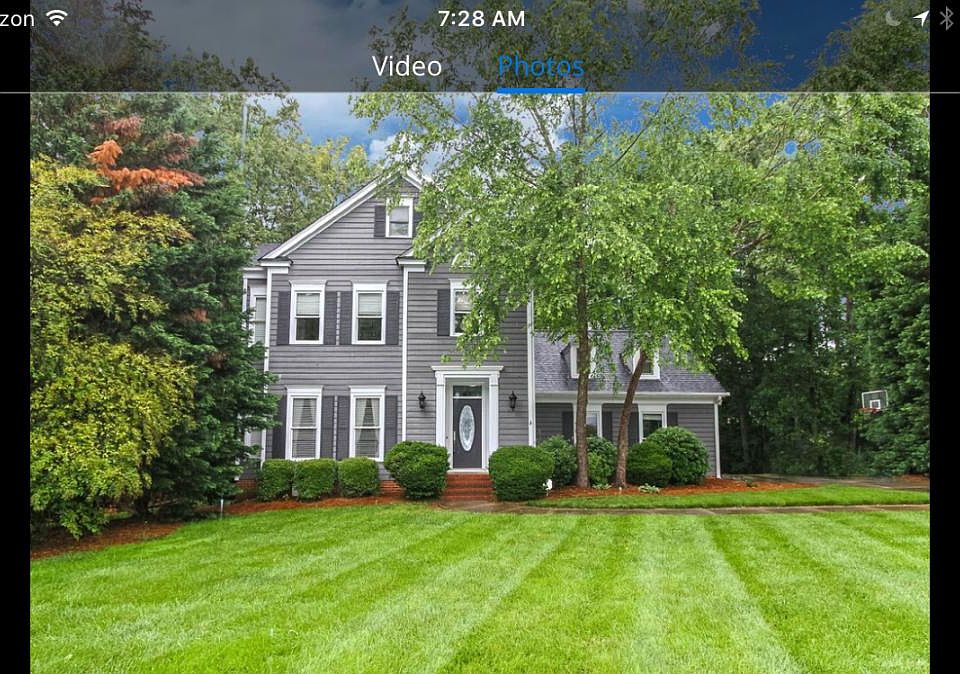 A level driveway with a generous parking pad has space for e
