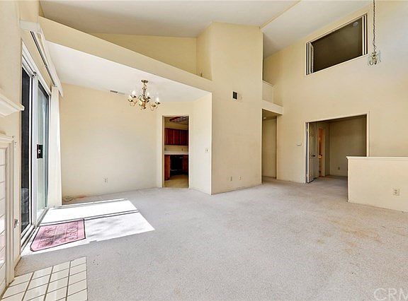 Plenty of natural light in living room with high vaulted ceiling.