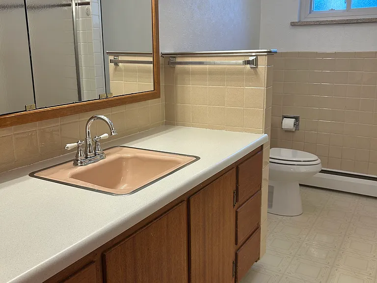 Master bathroom with tub, shower, and stackable washer/dryer