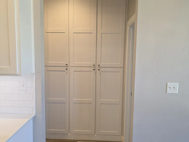 Storage in the hallway between two bedrooms on the other side of the home.
Neatly disguised behind beautiful cabinet doors.