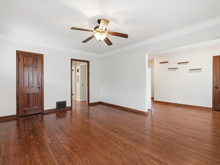 View of living room to dinette and hallway to main floor bedrooms and full bathroom