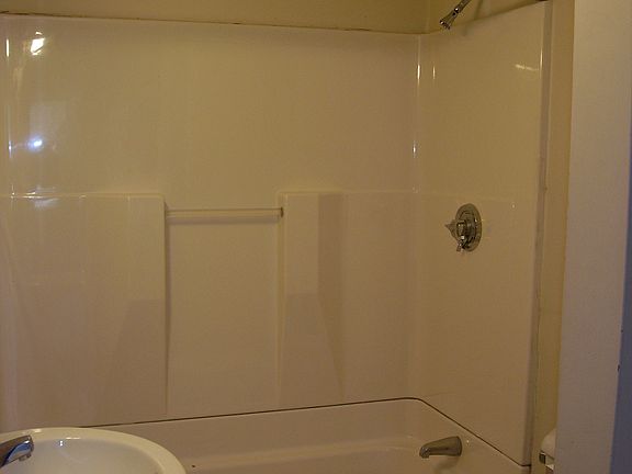 Modern bath with ceramic tile flooring.