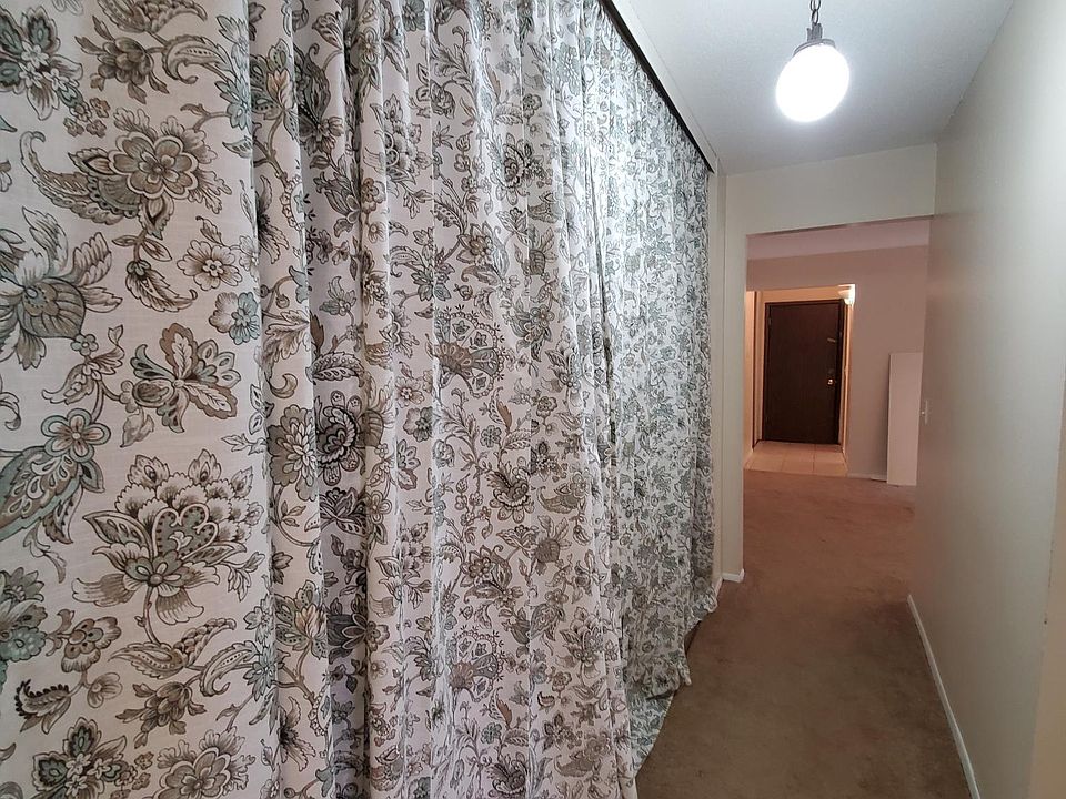 Main entry into the apartment, and the passageway to the bathroom and both bedrooms.