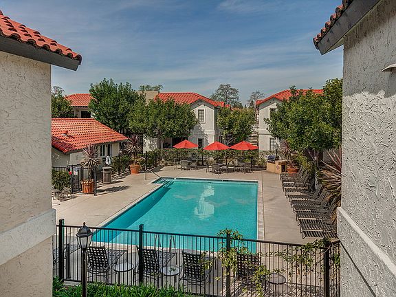Swimming pool surrounded by lounge chairs.