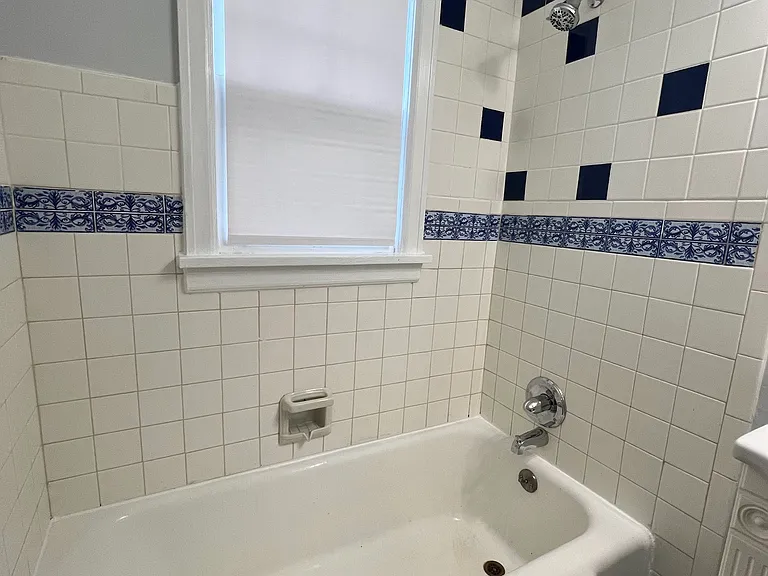 Bath tub and shower with updated hardware.