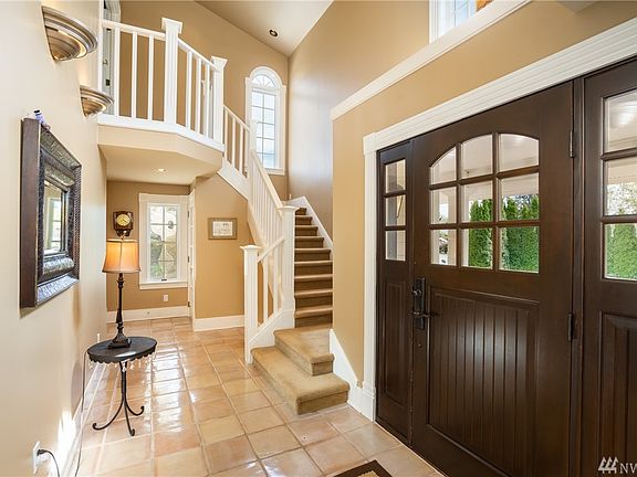 Whitewashed Terra-Cotta tiles brings a brightness to the interior. The stair case enters into a Beautiful Master Bedroom. Around the corner is the powder room and exit to the garage.