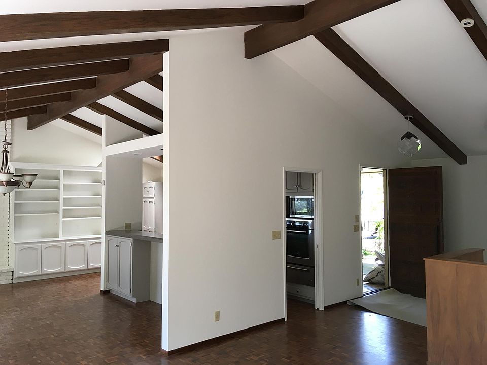 Top floor showing front entry, kitchen entry, dining room & built-in shelves & cabinets, from living room area.