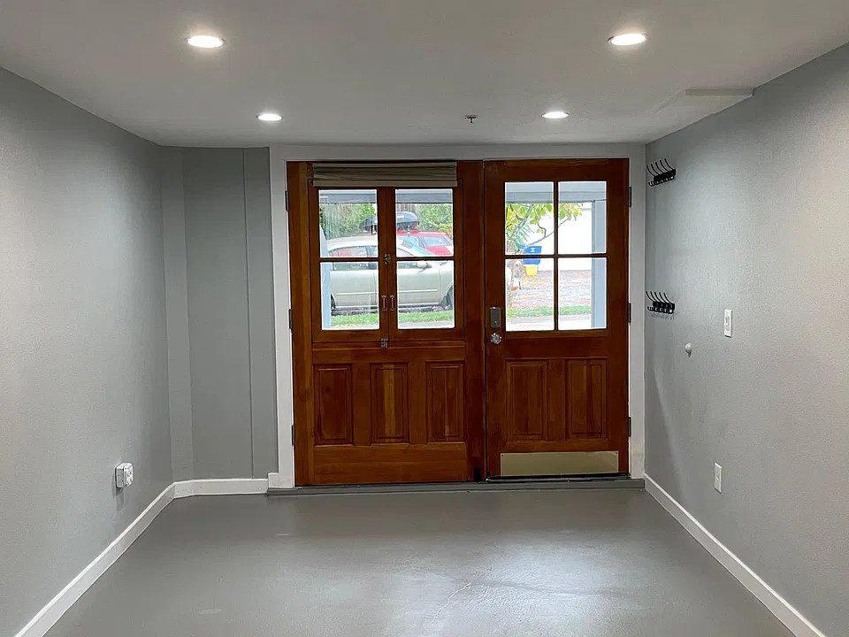 Large custom carriage doors both open to create an indoor/outdoor feel.