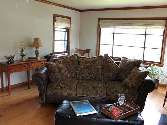 Freshly painted living room offers plenty of light from mahogany trimmed windows.