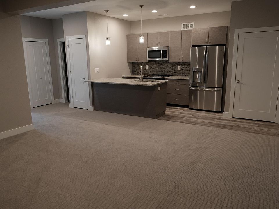 Plenty of room for bar stools at the island, a dining table and living room furniture in the open concept space. Note that door to the right is the laundry room with washer/dryer included.