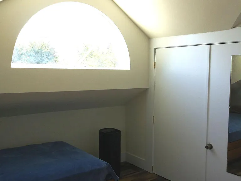 Bedroom. Note change in ceiling height. Closet gives extra buffer between units.