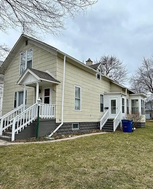 Exterior of Home showing side entrance to this unit. Entrance into unit is a couple steps inside the exterior door.