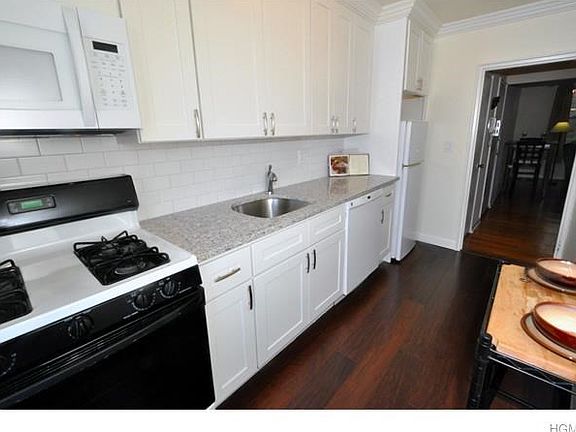 New Kitchen with granite counters, custom cabinets, crown molding and new appliances included dishwasher, microwave, range and refrigerator.