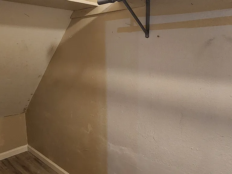 Large storage underneath the stairs plus rail to hang stuff.