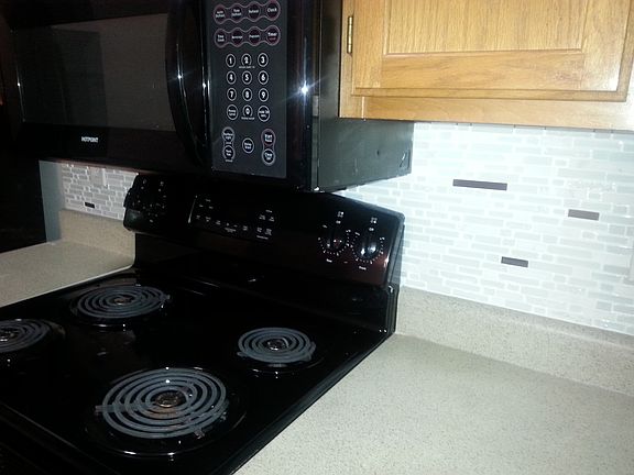 Real tile Back Splash & all Black Appliances