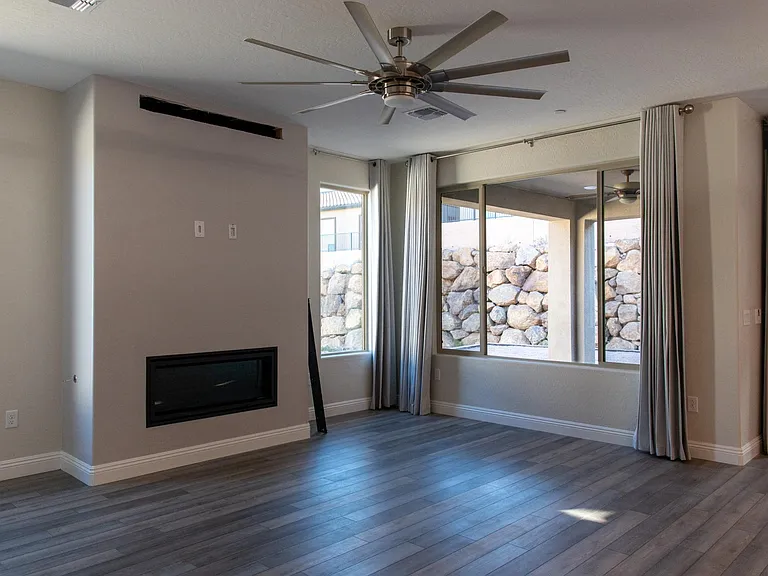 Great room featuring fireplace and fan light.