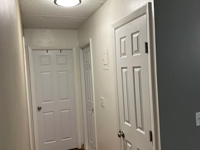 Hallway, first door on right is pantry. Second door on right is bathroom, door at end of hallway is the master bedroom