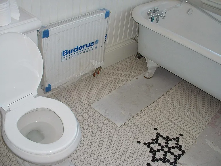 Typical hexagon tile design. All new plumbing and fixtures. "Buderus" is plastic covering on new radiator.