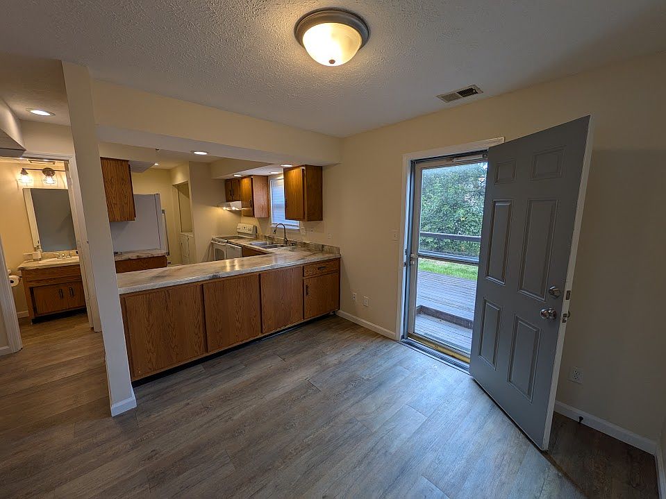 Dining area and kitchen space. Excellent couterspace for entertaining! Back door leads to back patio.