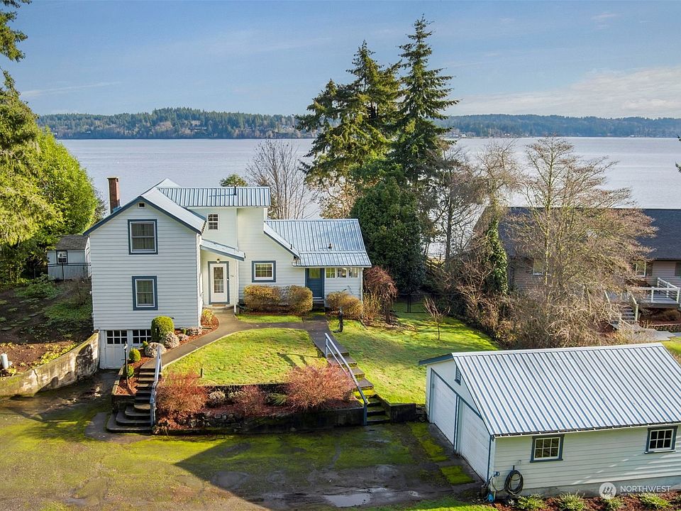 Enjoy amazing views of Dyes Inlet from this charming and loved waterfront home on a 1.10 acre private and peaceful property. >