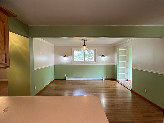 Kitchen looking towards dining area. Hall to the left leads to rest of apartment. Living room is to the right.