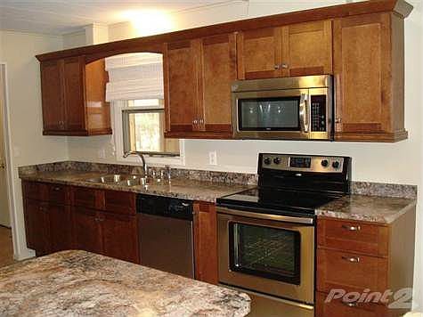 The kitchen is brand new with gorgeous cherry cabinets, new stainless appliances and fixtures and tile floor.