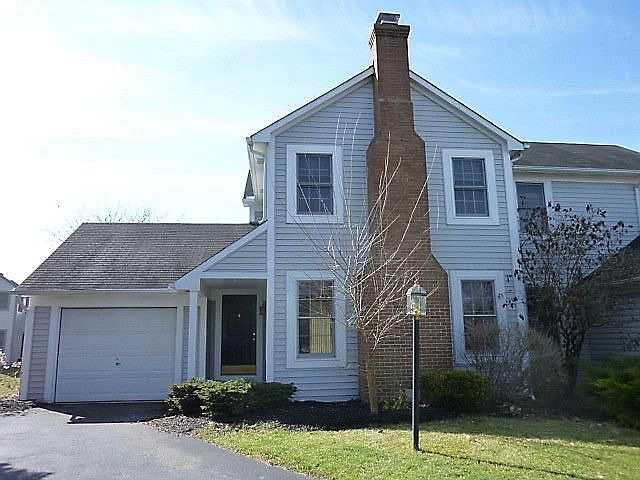Vinyl exterior with brick chimney and one car garage