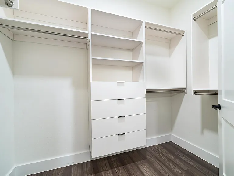 Custom built-ins and dual hanging rods make it easy to keep everything organized in this oversized closet.