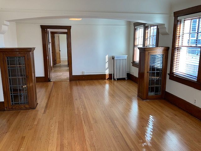 Stunning living room to dining room view. All hardwood floors. Beautiful built-ins. Window treatments.