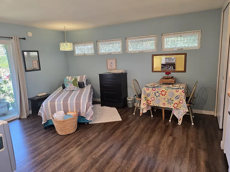Solid wood folding table. Seats four comfortably when fully open. Folds down to only 8 inches deep. Has wheels to move.