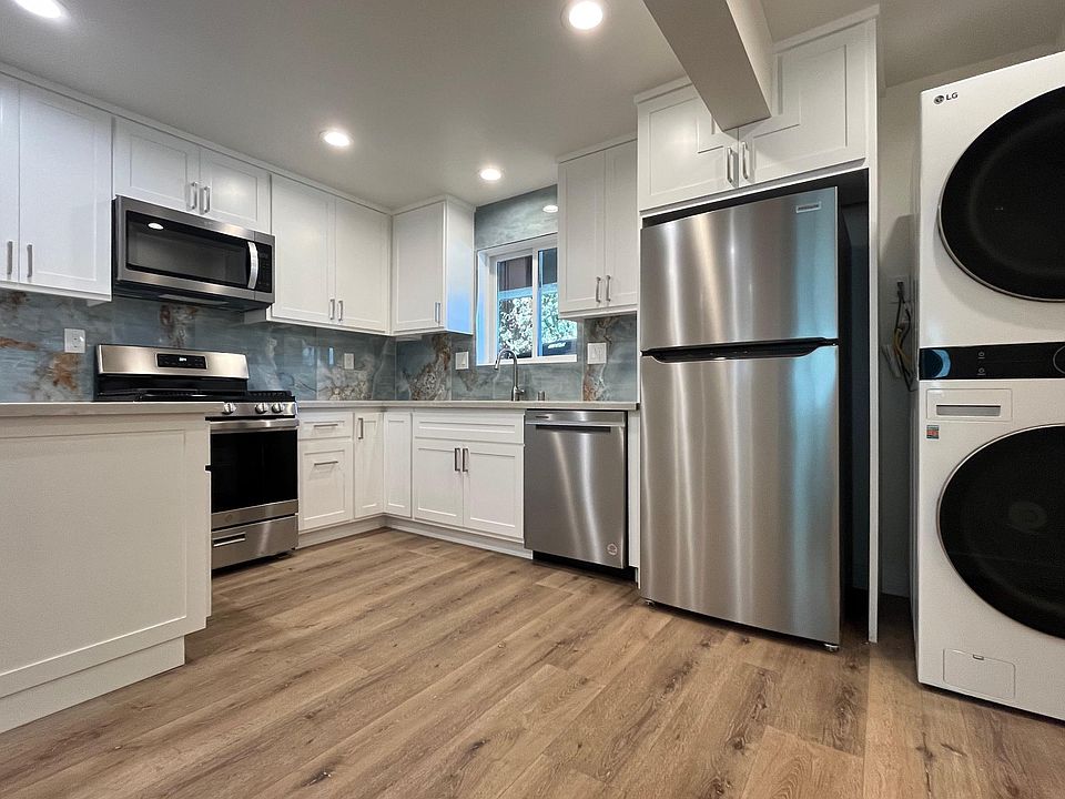Open-concept kitchen with stainless-steel appliance and in-unit laundry