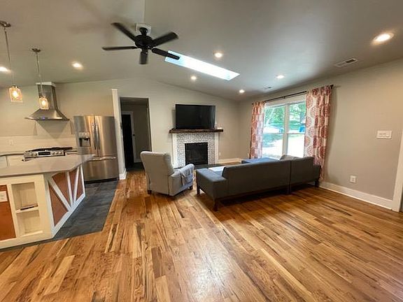 Bright open floor plan with skylight and gas fireplace